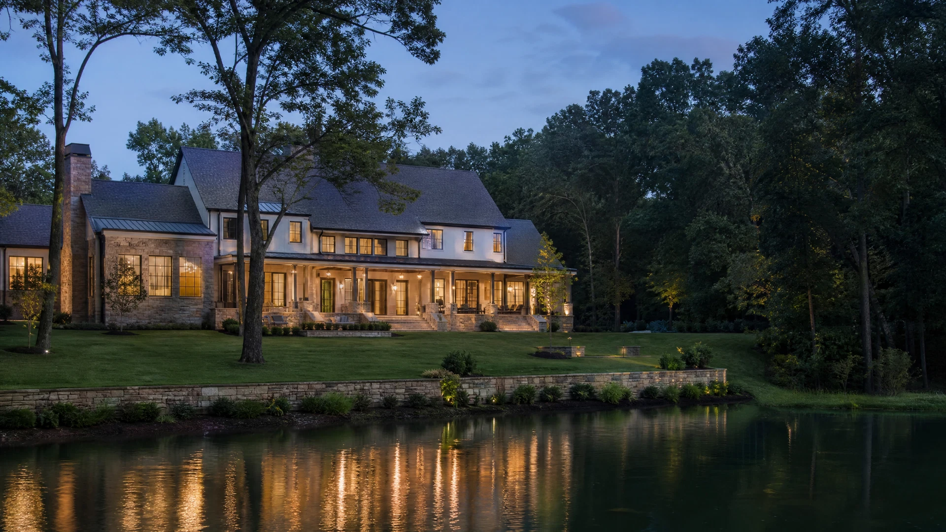Private contemporary Southern estate beside still water and mature trees