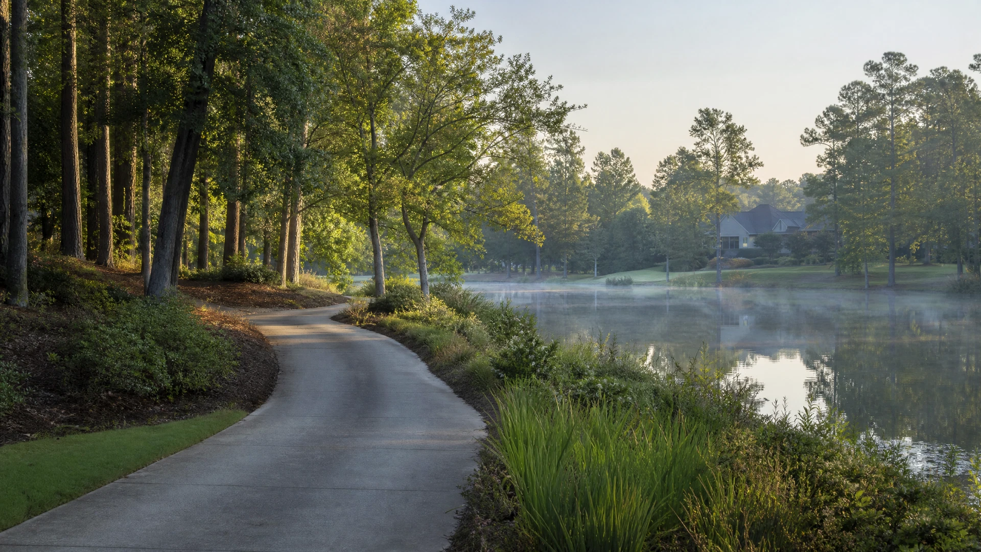 Tree-lined waterside greenway representing the lifestyle of Metro Atlanta communities